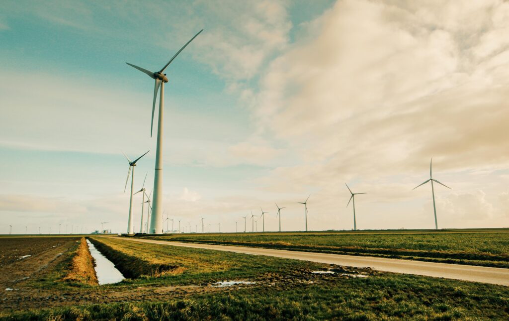 Scenic view of wind turbines in a rural Dutch landscape, generating renewable energy.